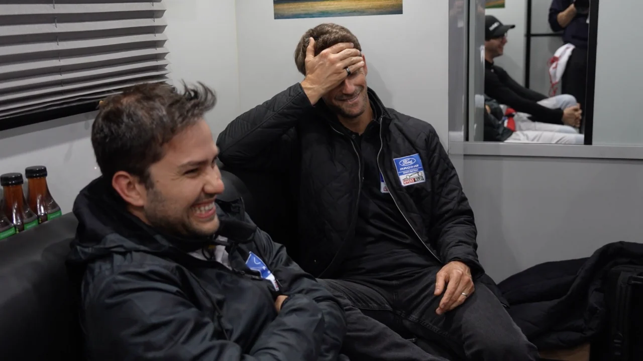 Felipe Fraga and Romain Grosjean laughing in the drivers' debrief room ahead of the 2026 Rolex 24 at Daytona