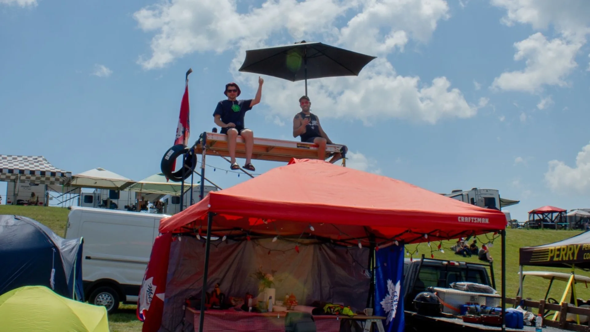 Two campers on their makeshift scaffolding on the inside of Turn 3