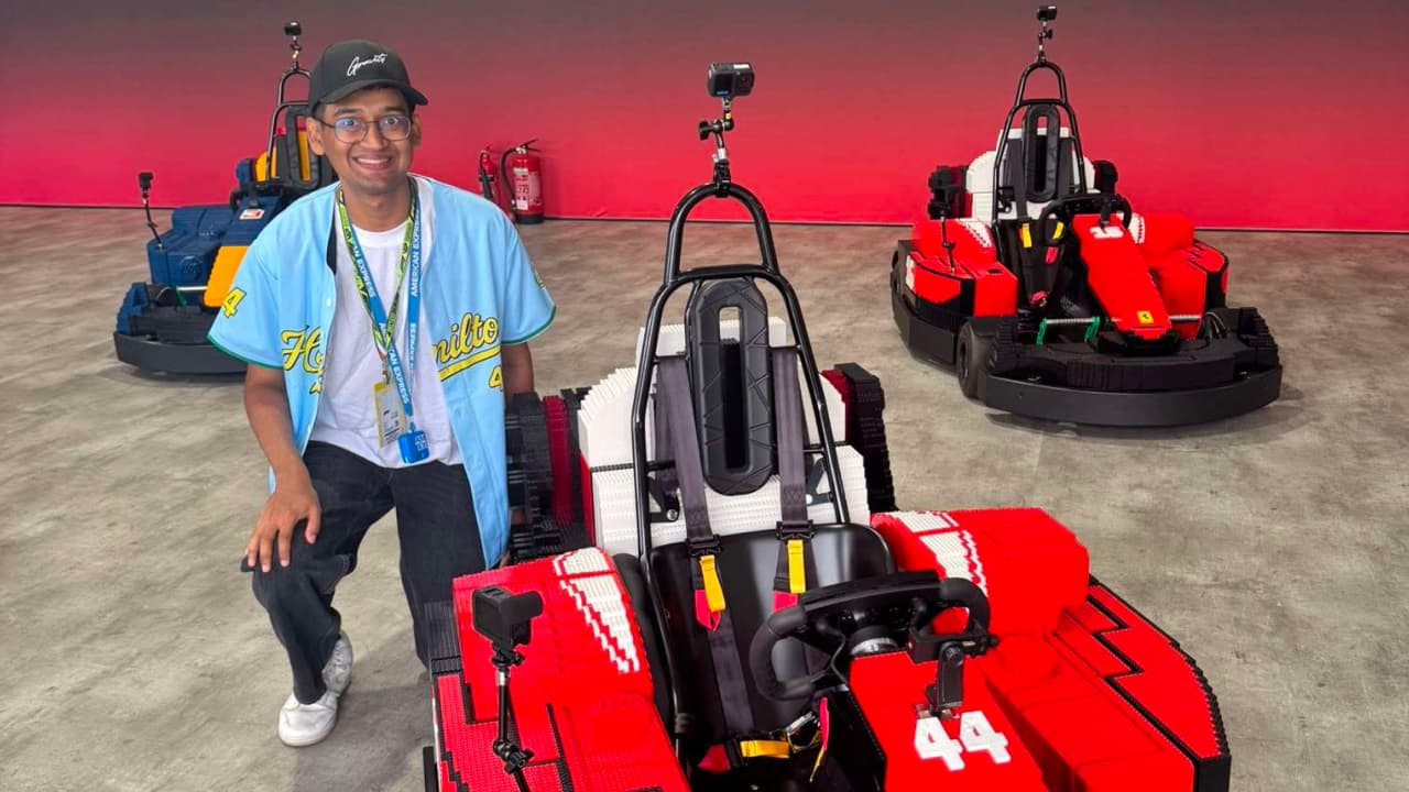 Gavin De Sourza posing with Lewis Hamilton’s LEGO Ferrari car
