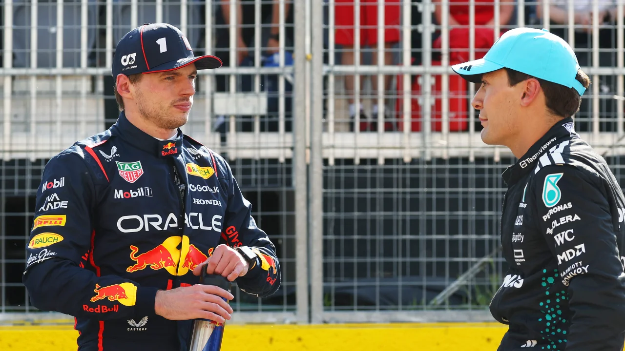 George Russell of Mercedes AMG Petronas F1 Team and Max Verstappen of Oracle Red Bull Racing talk in parc ferme during qualifying ahead of the F1 Grand Prix of Canada at Circuit Gilles-Villeneuve. (Photo by Mark Thompson/Getty Images via Red Bull Content Pool)