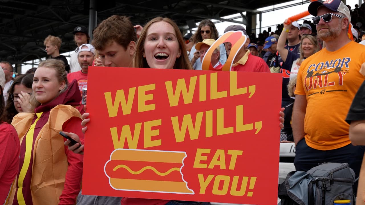 A Wienie 500 fan in the grandstands with their sign