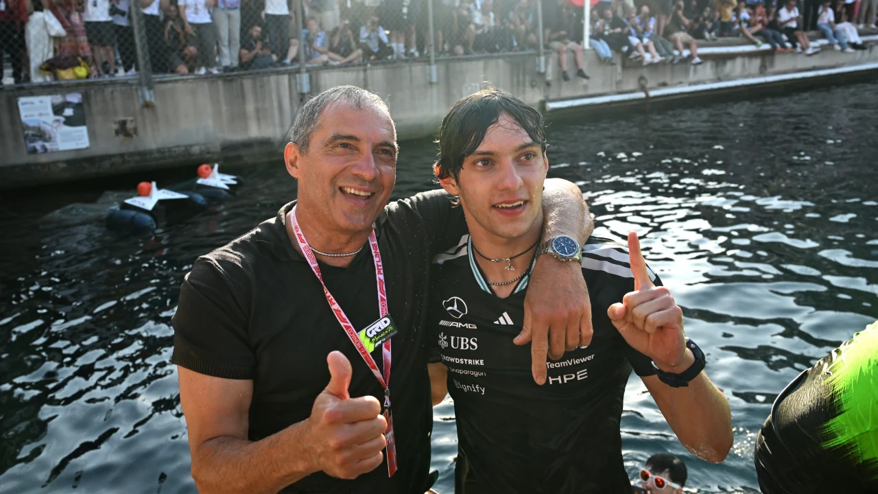 Kimi Antonelli and his father Marco stand soaking wet after celebrating his win at the 2026 Monaco Grand Prix. Source: Mercedes-Benz Media Centre