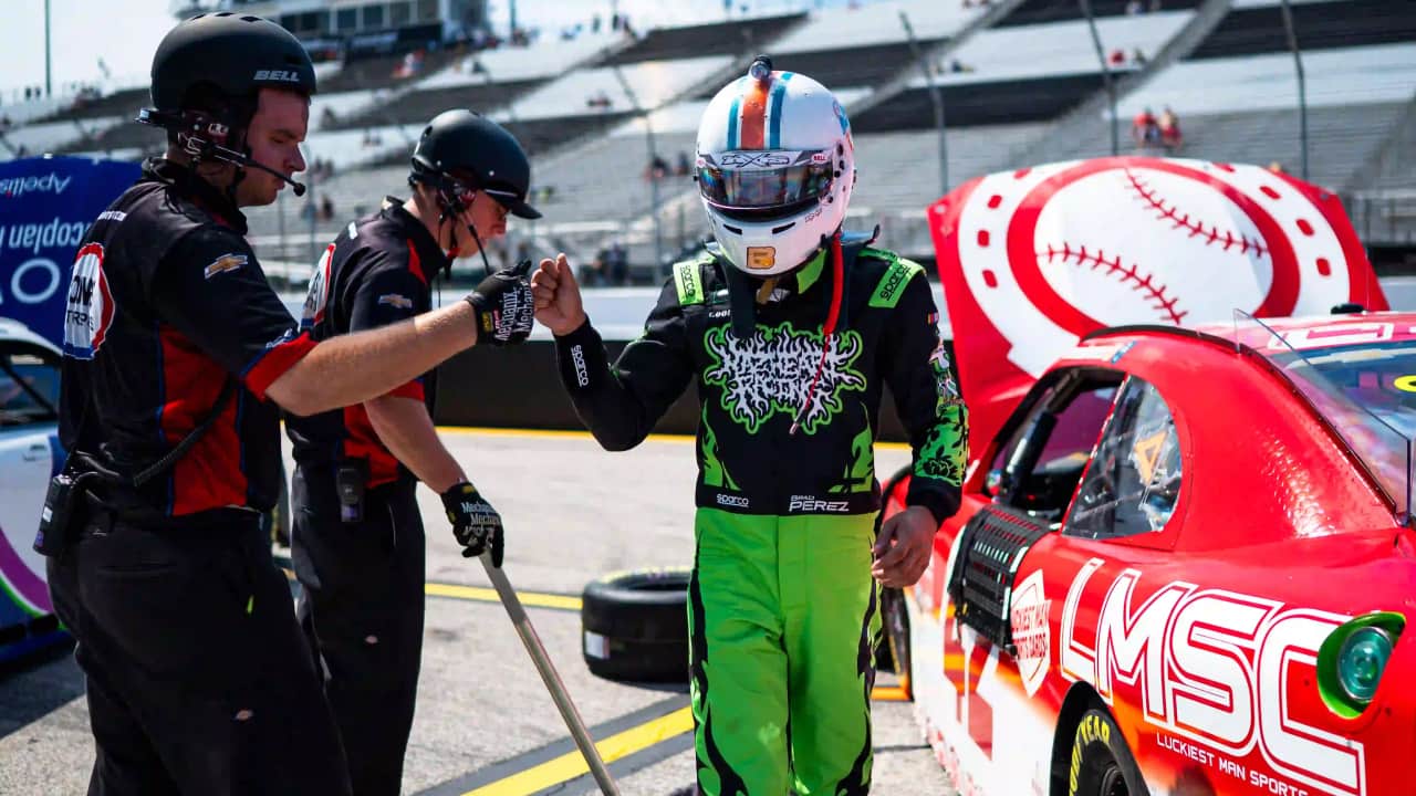 NASCAR O'Reilly Series driver Brad Perez fist bumps one of his crew members before climbing in his race car. (Photo: Daylon Barr)