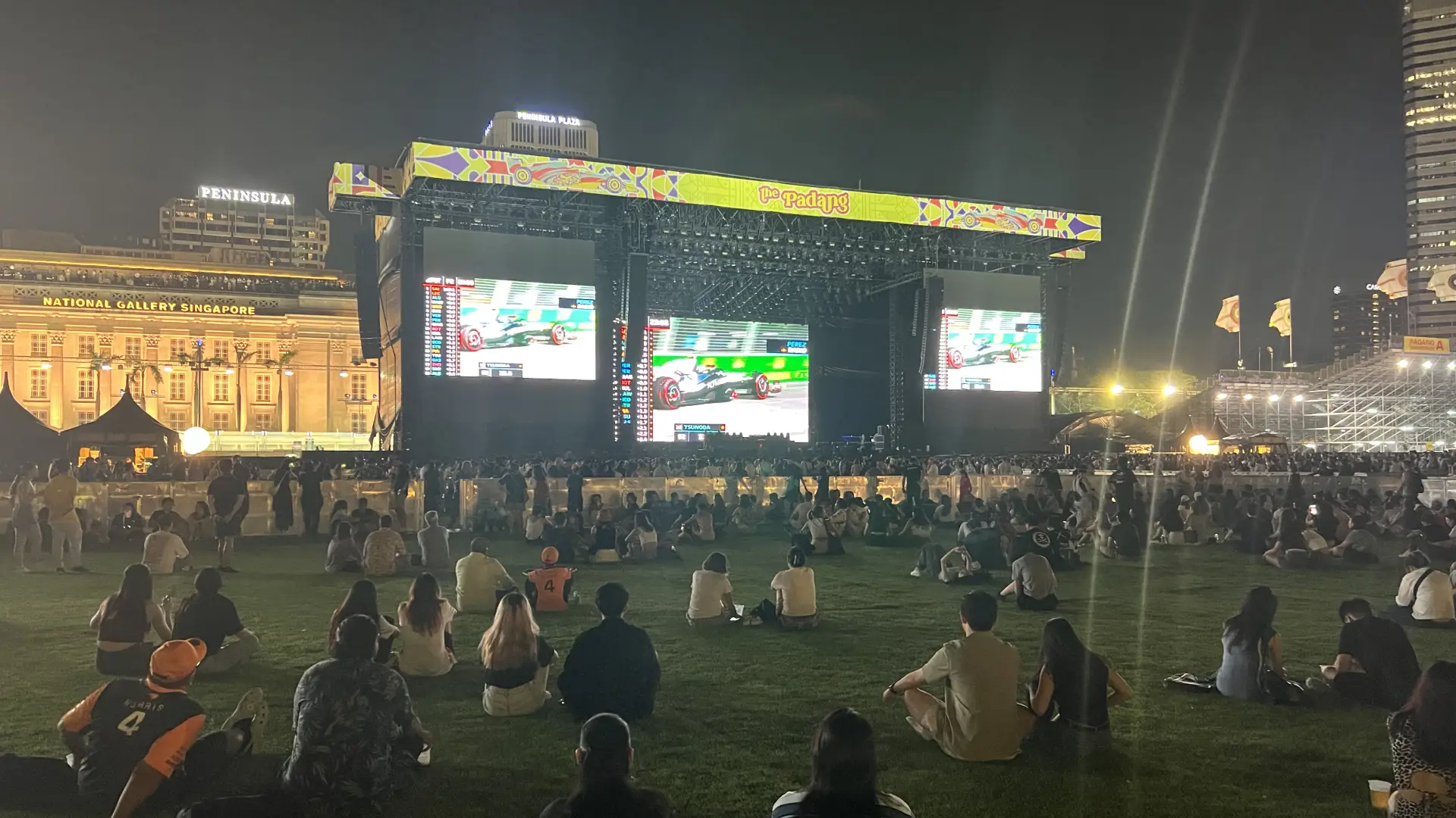 Fans watch F1 cars race on The Padang Stage screens at the Singapore GP. (Photo: Greg Kallman/FanAmp)