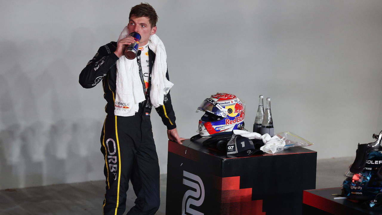 Max Verstappen, with a towel around his neck, rehydrates after finishing the 2025 Singapore Grand Prix. (Photo: Mark Thompson, Getty Images/Red Bull Content Pool)