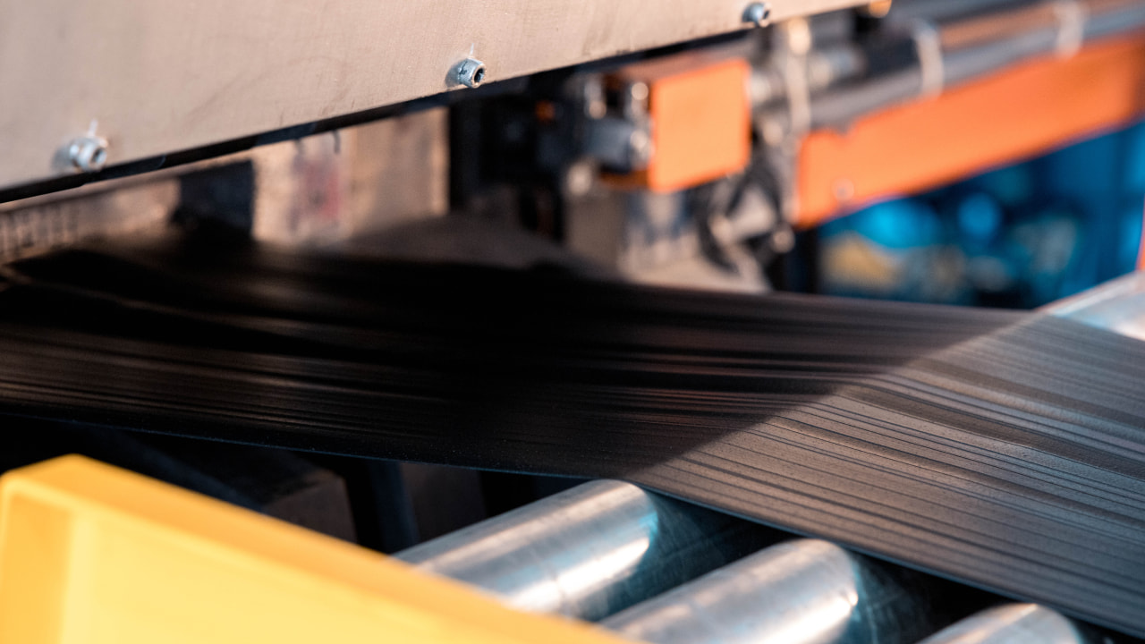 In order to shape a tire, Bridgestone must flatten its rubber mixture into uniform sheets. (Photo credit: Bridgestone)