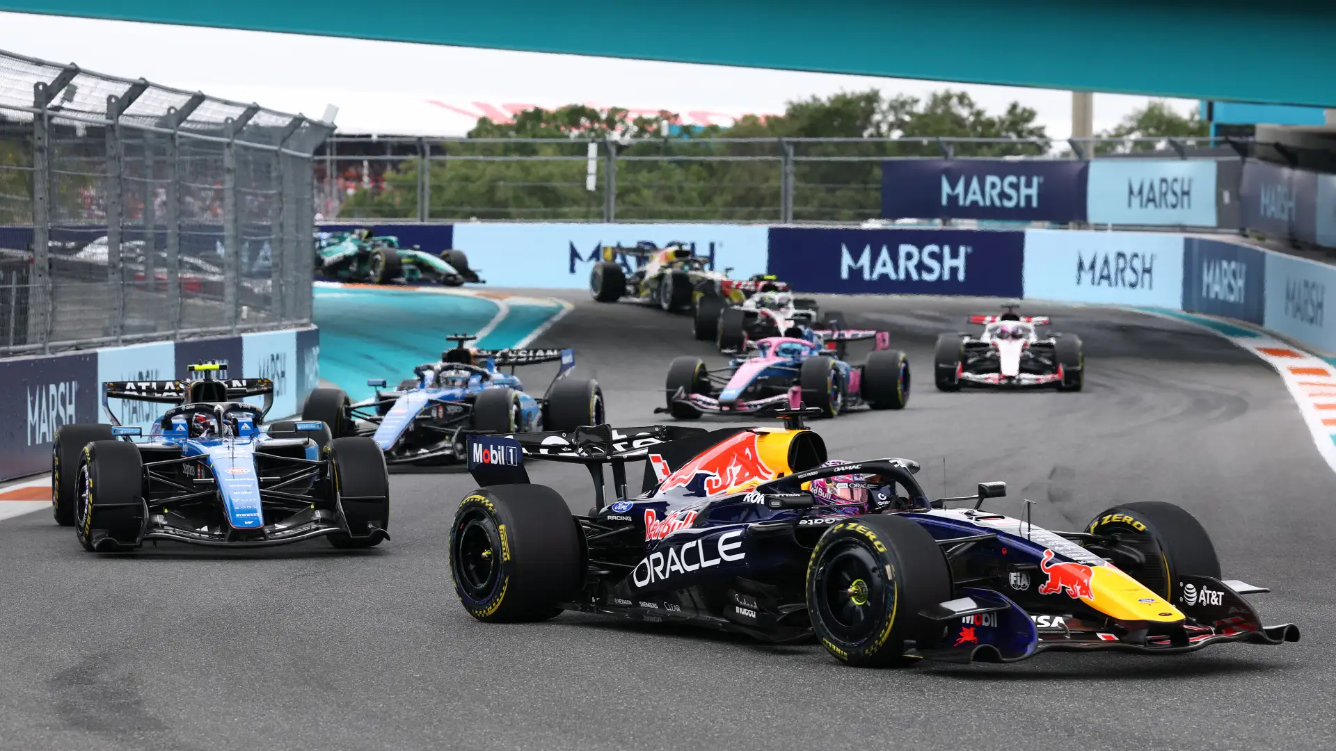 Marsh’s trackside signage was first introduced at the 2026 Miami Grand Prix, seen here behind Max Verstappen leading a pack of Formula 1 cars. (Photo: Clive Mason, Getty Images/Red Bull Content Pool)