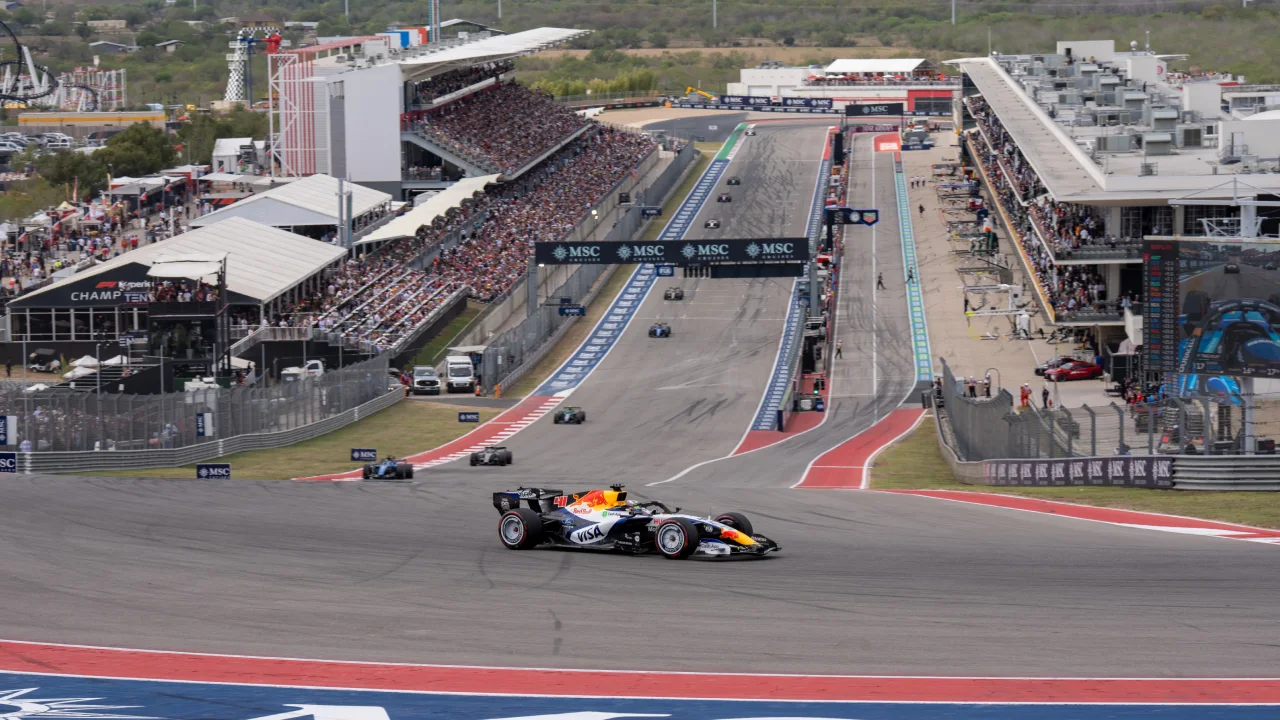 A Racing Bulls car takes Turn 1 ahead at the start of the 2026 US Grand Prix. (Photo: Greg Kallman/FanAmp)