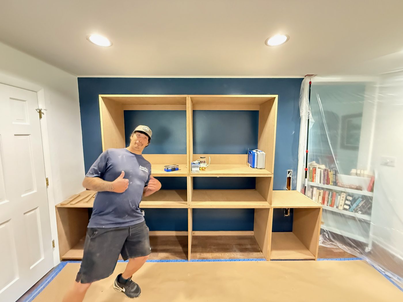 Crew member giving a thumbs up during a custom built-in installation