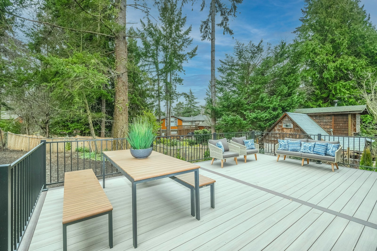 Backyard wood deck with outdoor furniture on finished boards