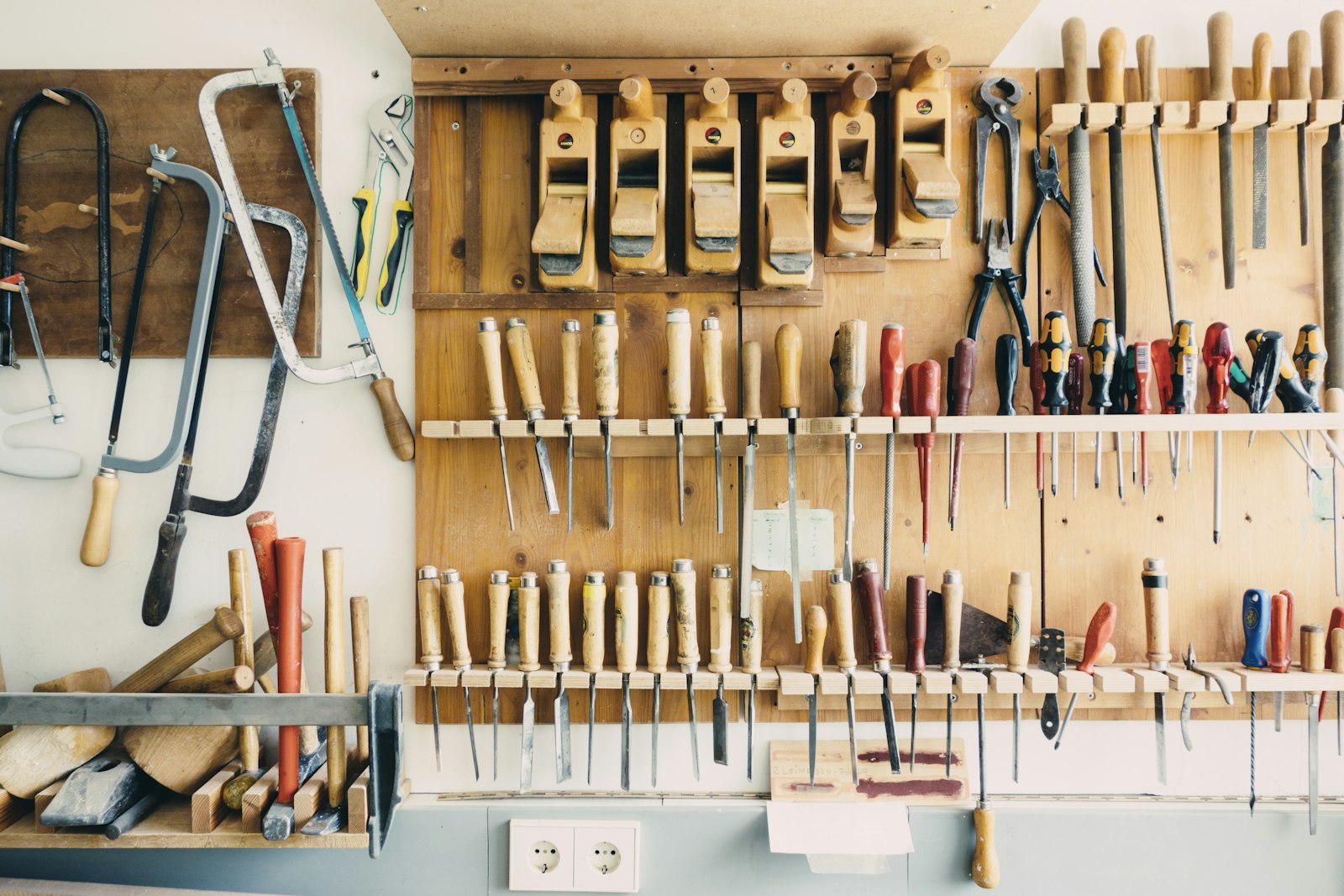 Hand tools on a workshop rack