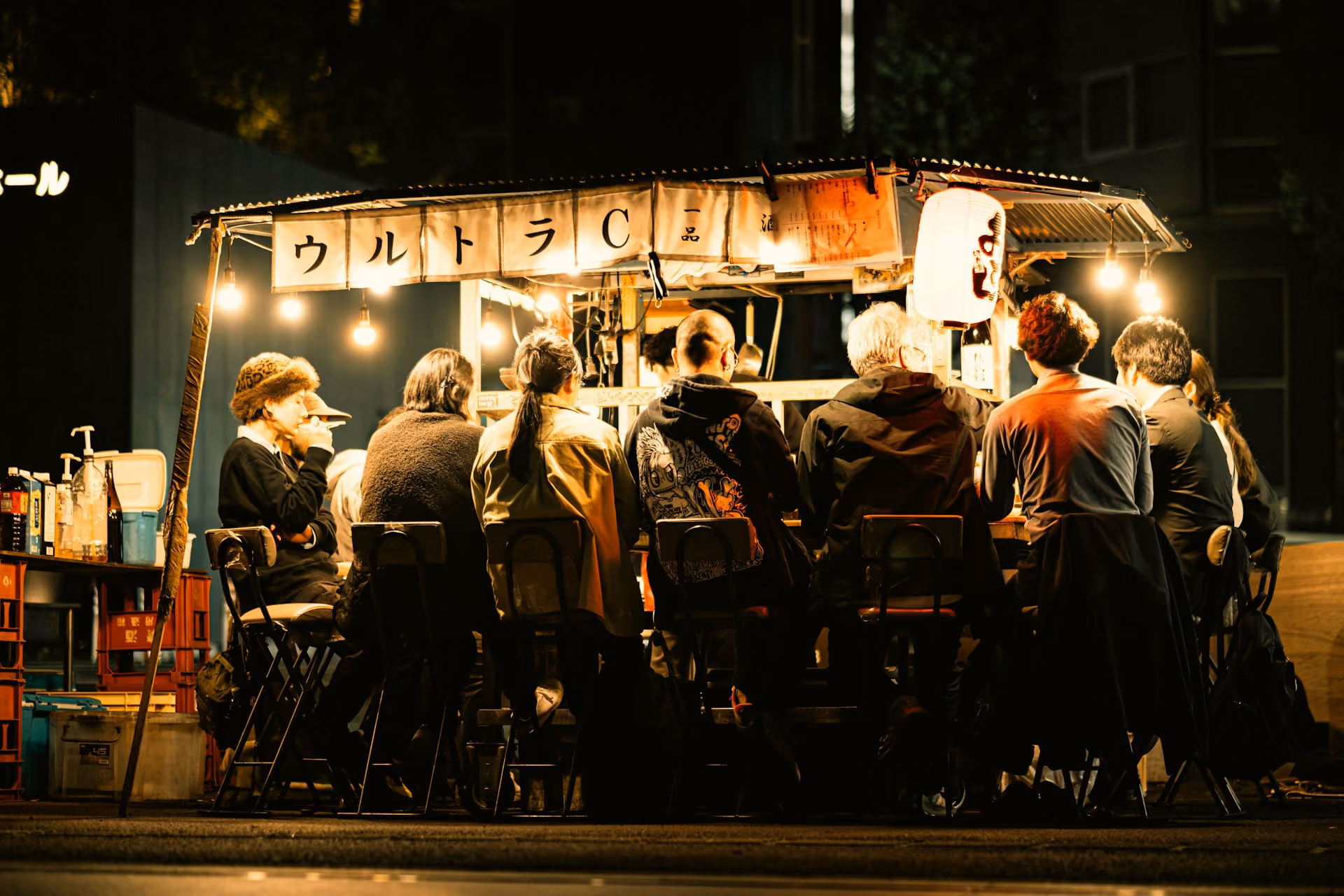 Diners gathered at a Fukuoka street food stall at night