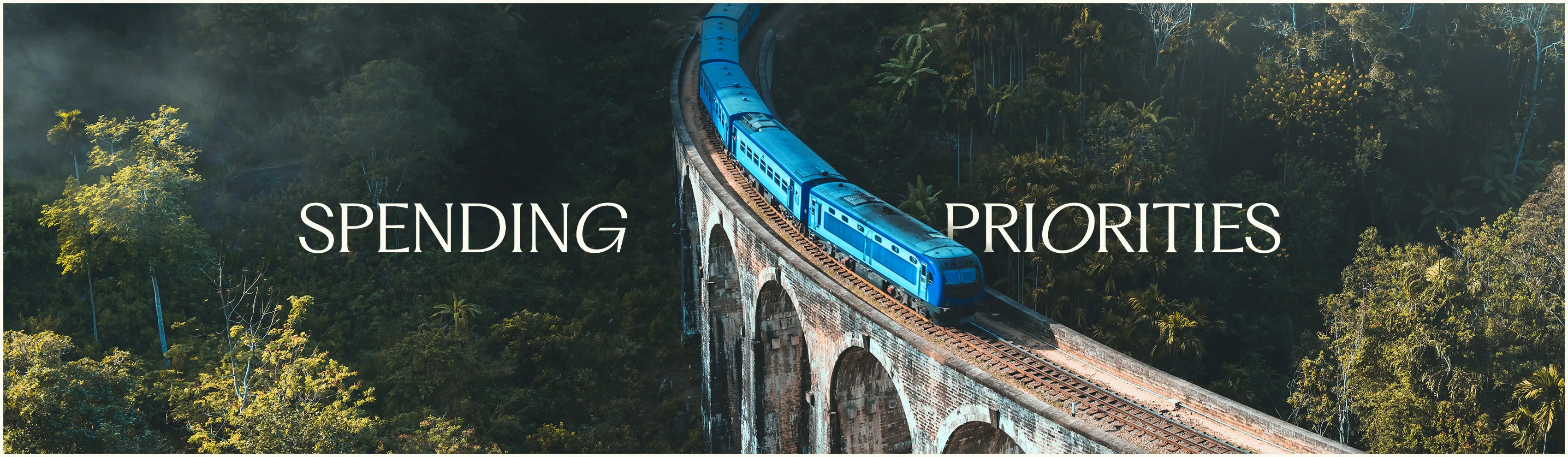 "Spending Priorities" slide from the Hilton production with a photo of a blue train on a viaduct through rainforest