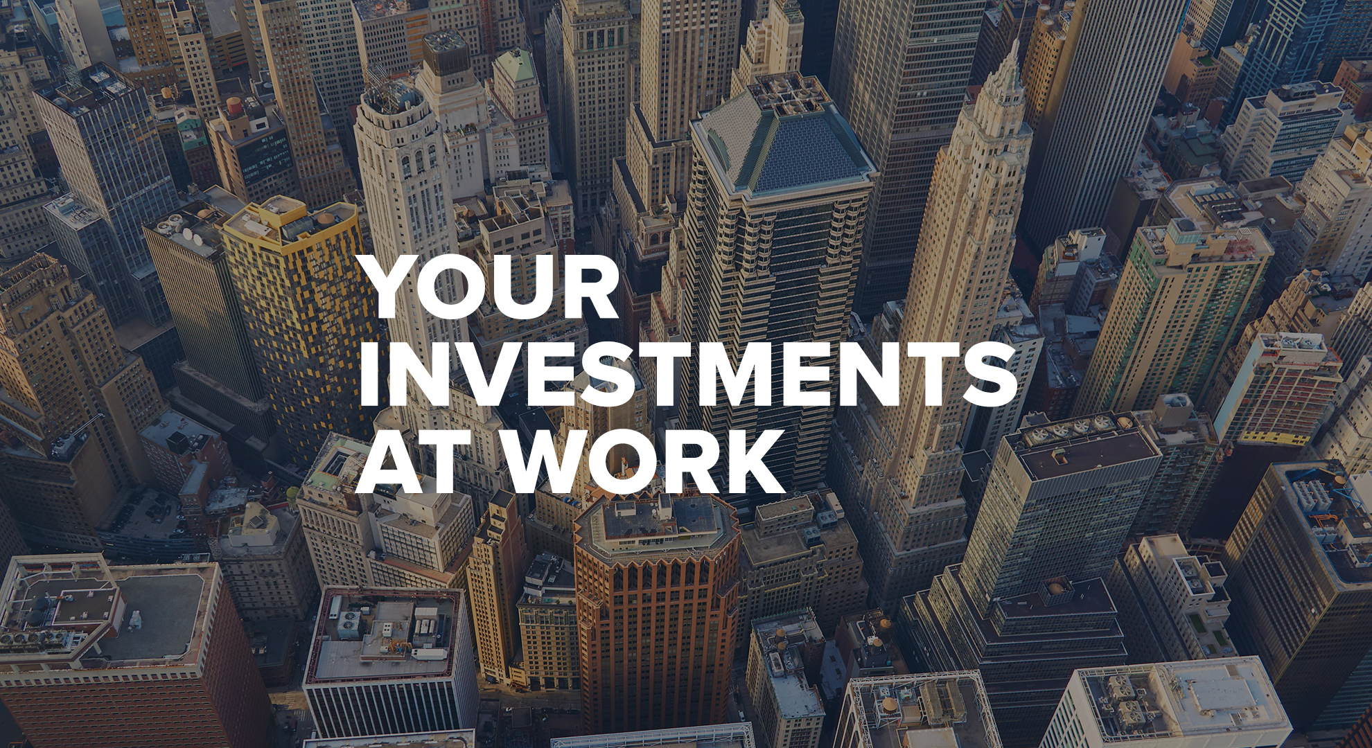 Your investments at work — aerial view of a dense cluster of city skyscrapers.