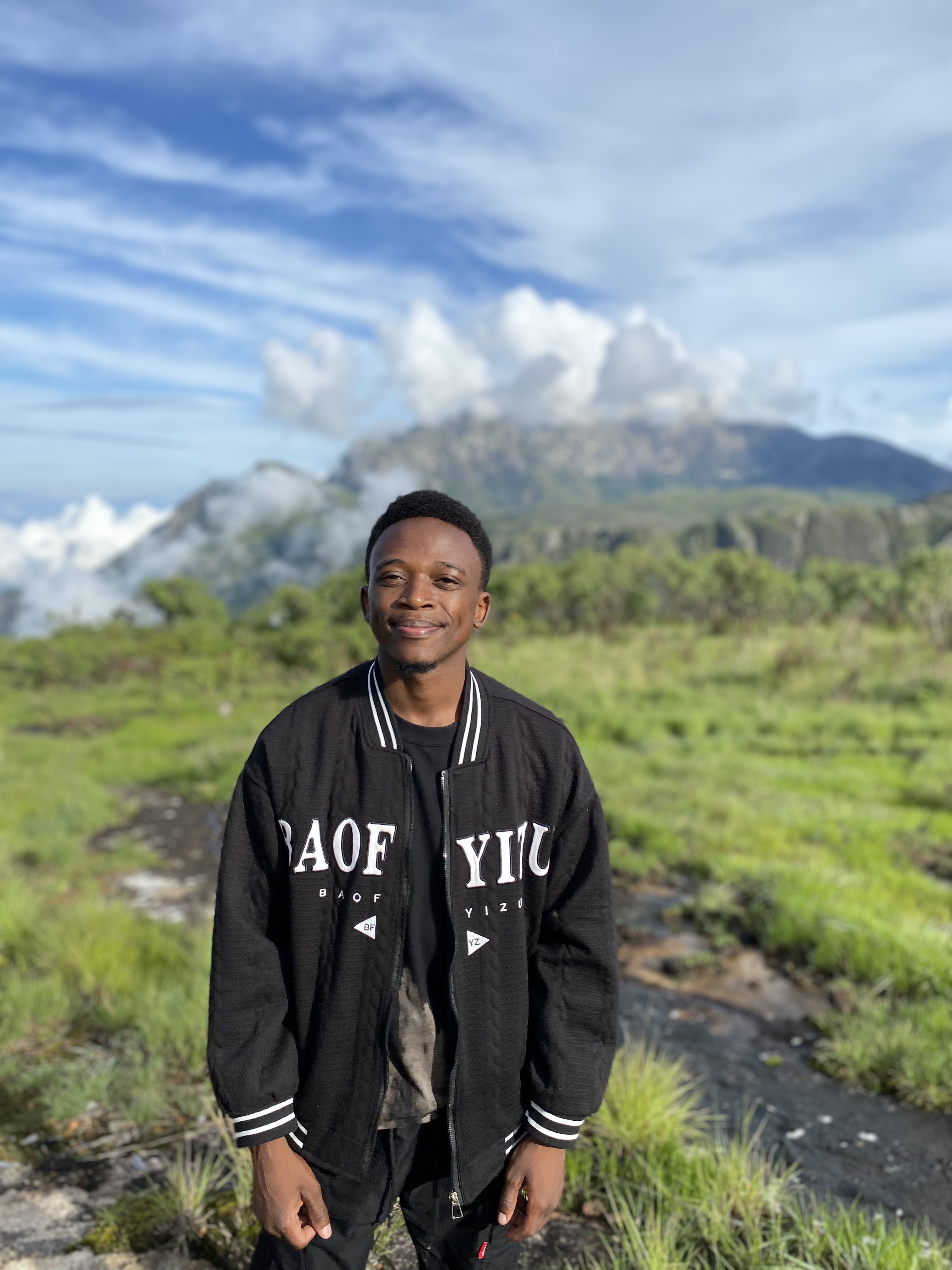 A picture of Ernest hiking Mulanje Mountain in Malawi