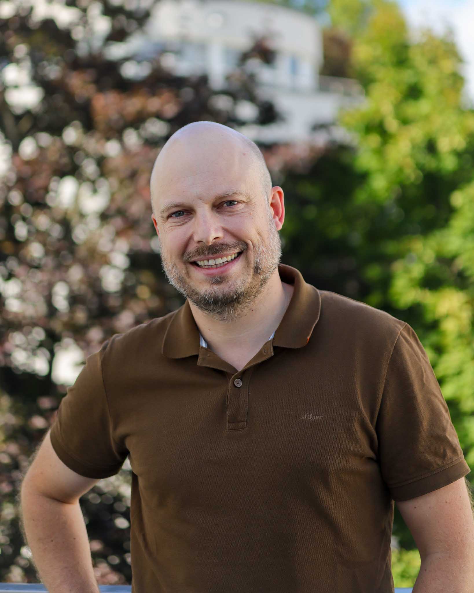 A polite sales manager laughing into the camera; ready to talk about your processes with you!