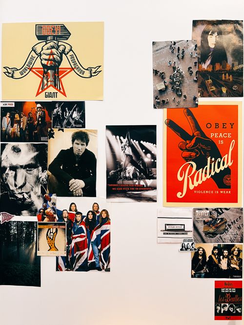 Close up image of musical and political posters on a wall in various sizes
