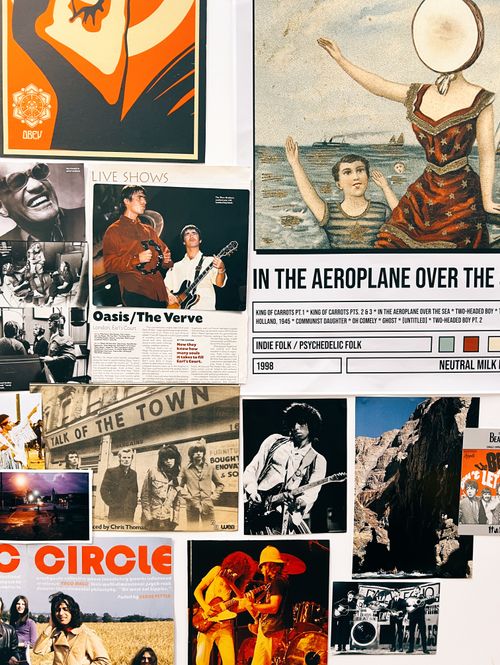 Close up image of musical and political posters on a wall in various sizes