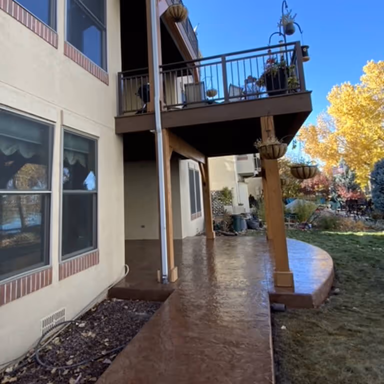 Upper Level Deck with wood columns and over a Stamped Concrete Patio