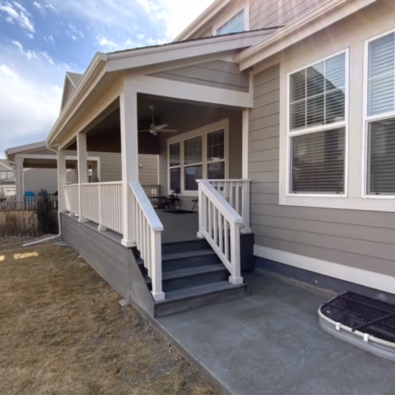 Covered Deck with White wood rails.