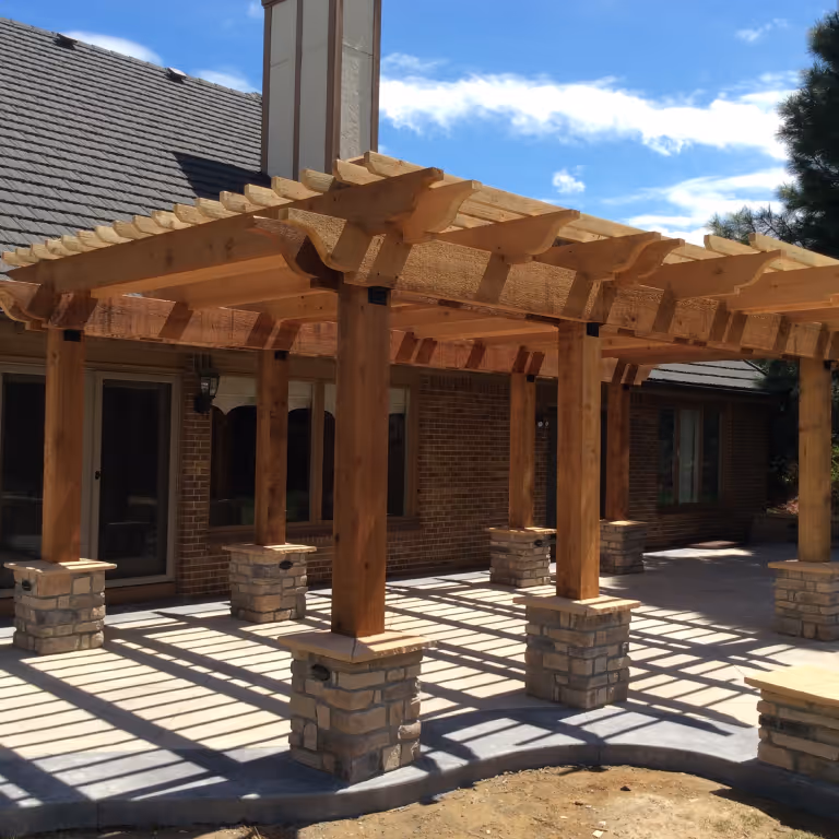 Stunning Heavy Timber Pergola with faux stone bases on Concrete Patio