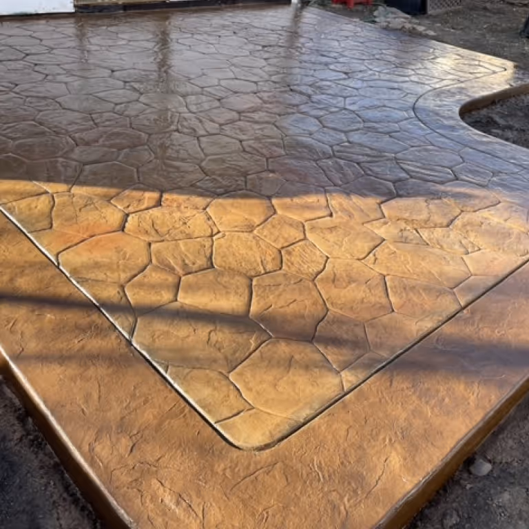 Decorative Stamped Concrete Patio with two tones of Auburn color
