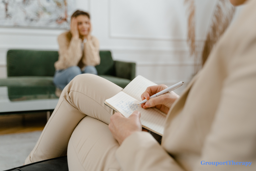 Counselor taking notes during a therapy session focused on emotional regulation, intimacy, and difficult impulses.