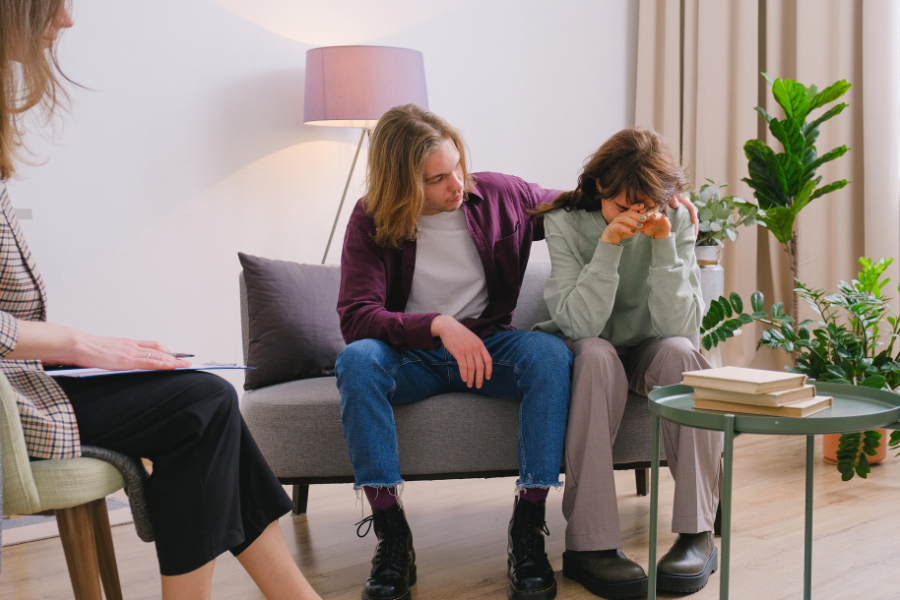 Couple receiving emotional support during an in-person couples therapy session