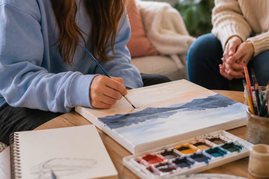 Adolescent girl painting during expressive arts therapy with supportive guidance at Imperial Healing House in Provo, Utah.