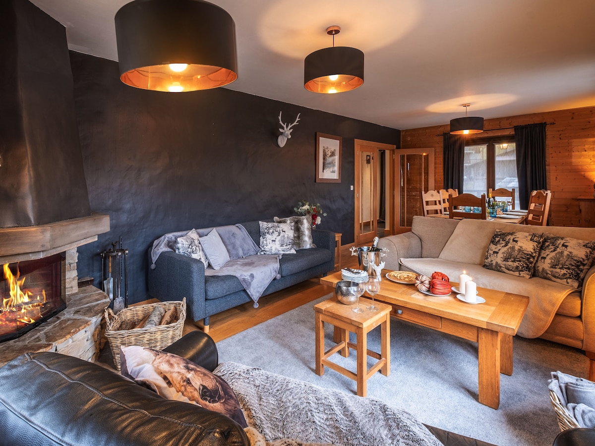 Living room with log fire at Chalet Bolay, Montriond near Morzine