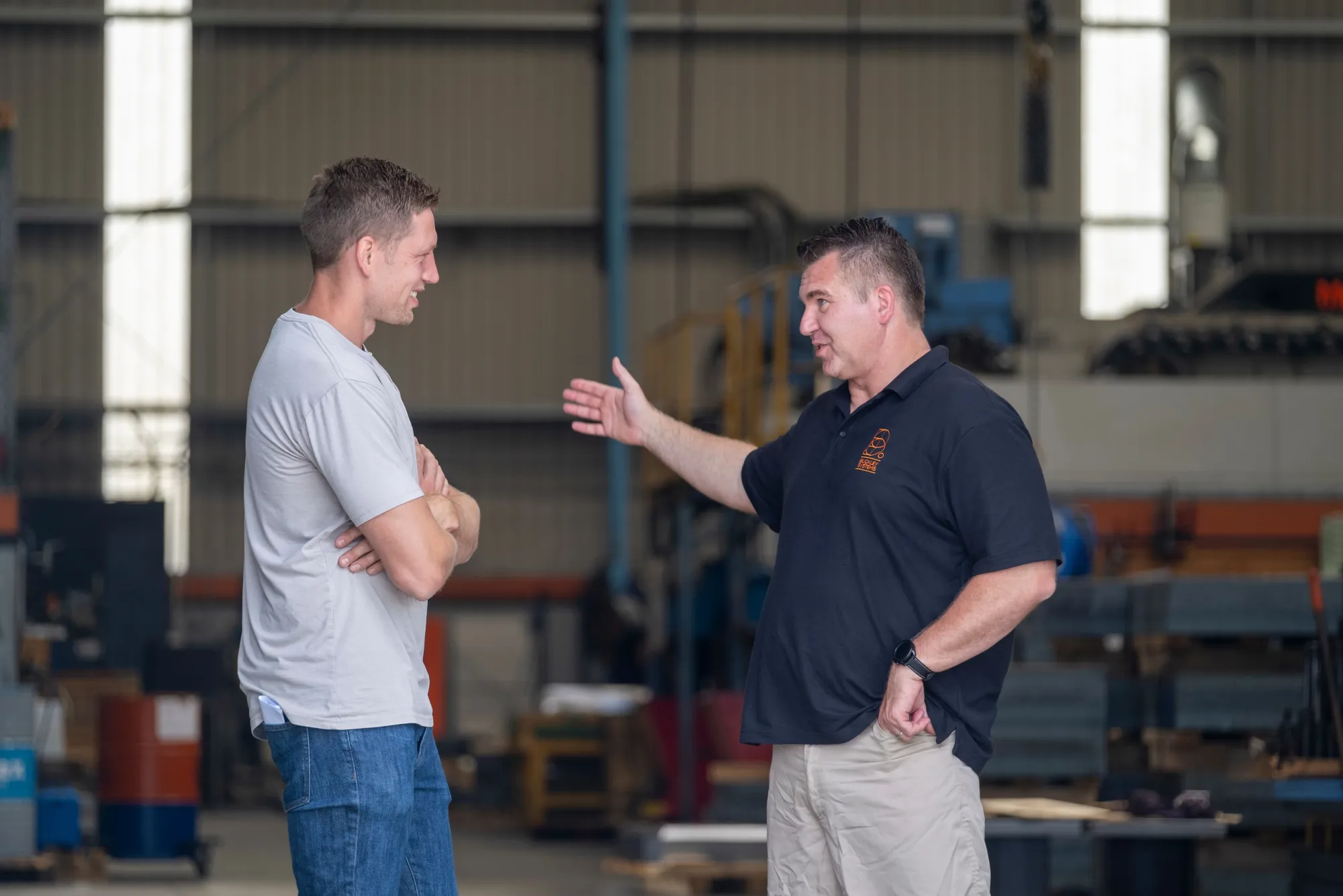 A coach and apprentice on the workshop floor
