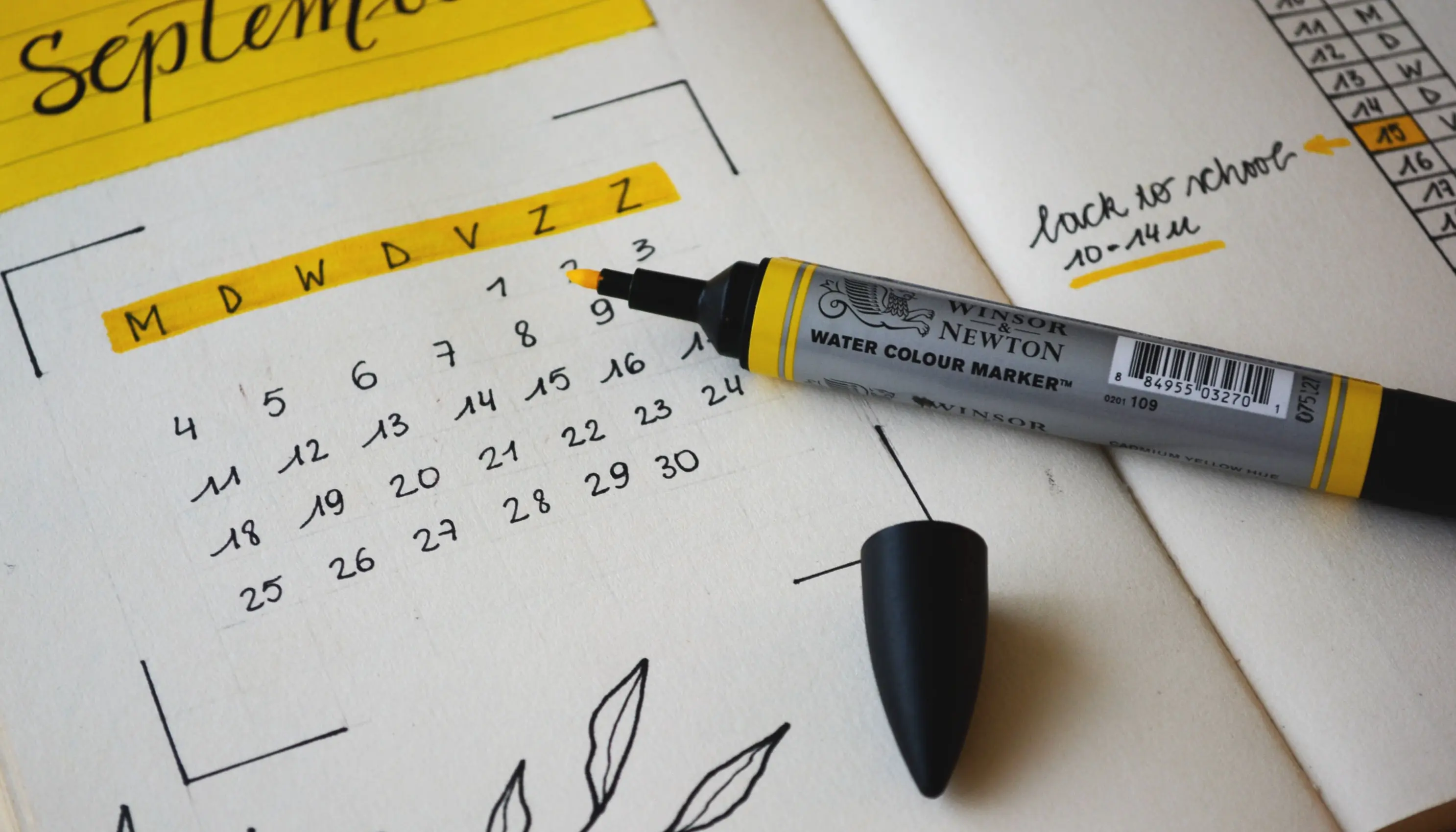 Image of a yellow highlighter laying on a calendar with the days of the week highlighted