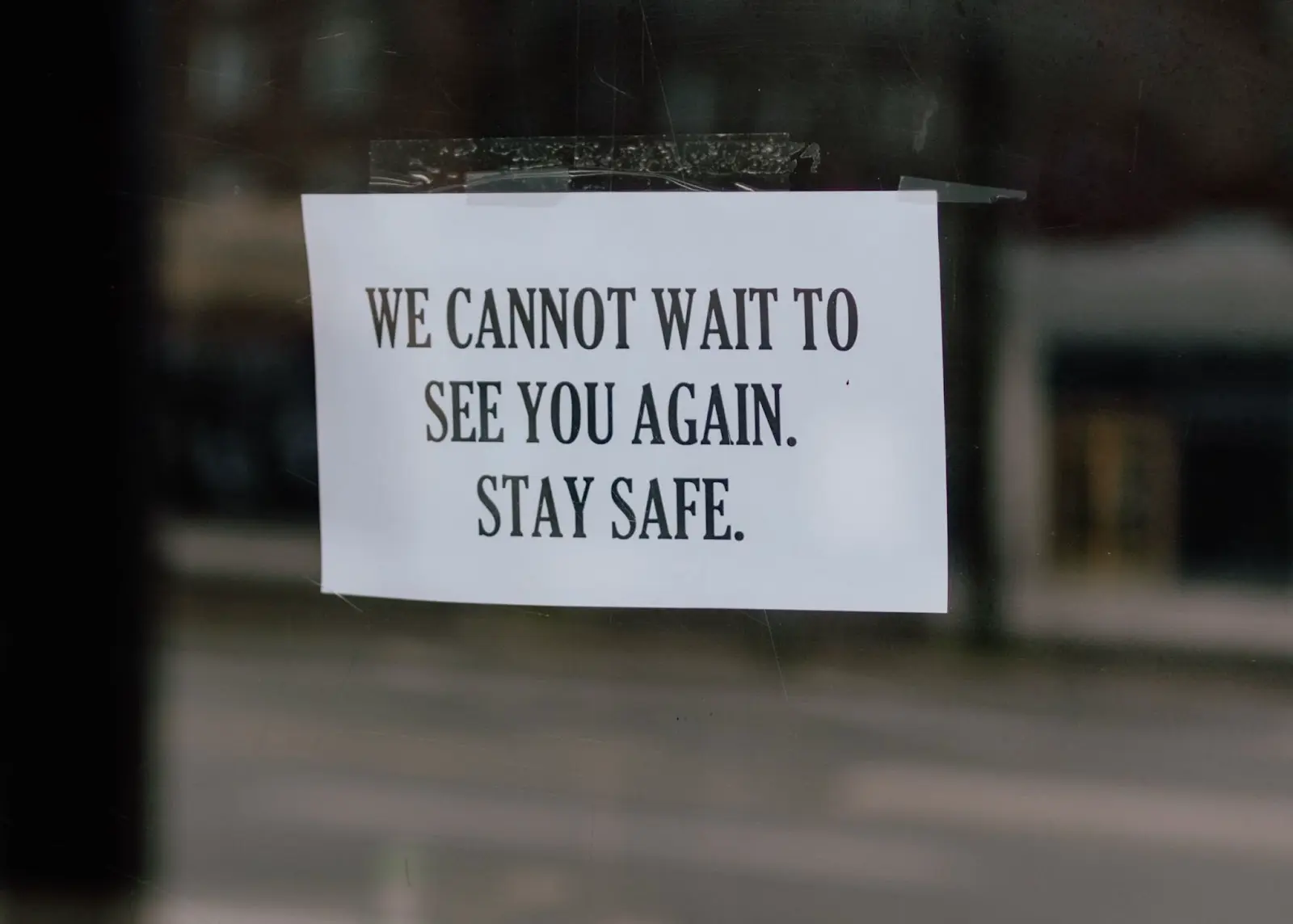 A piece of paper on the window: We cannot wait to see you again. Stay Safe