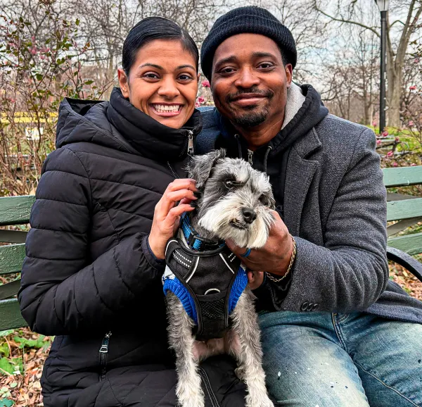 Guinness the dog with their pet parents.