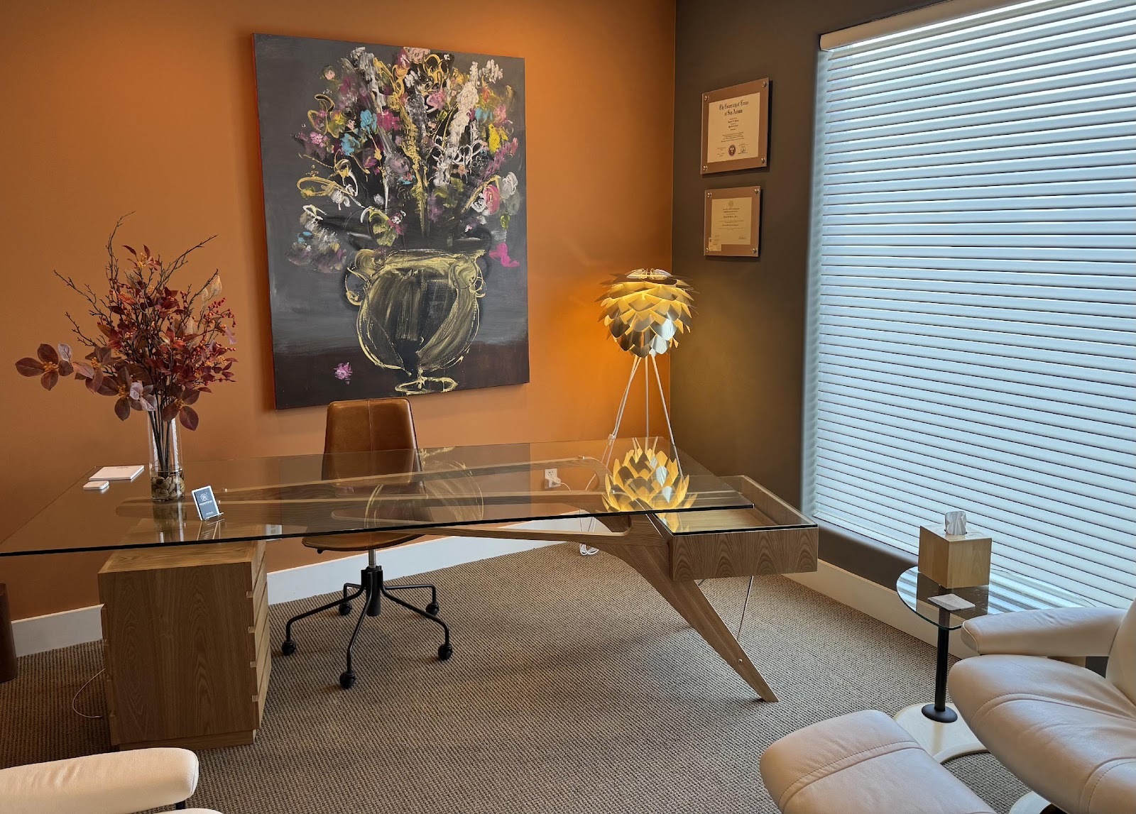 Modern office workspace with desk and artwork on the wa