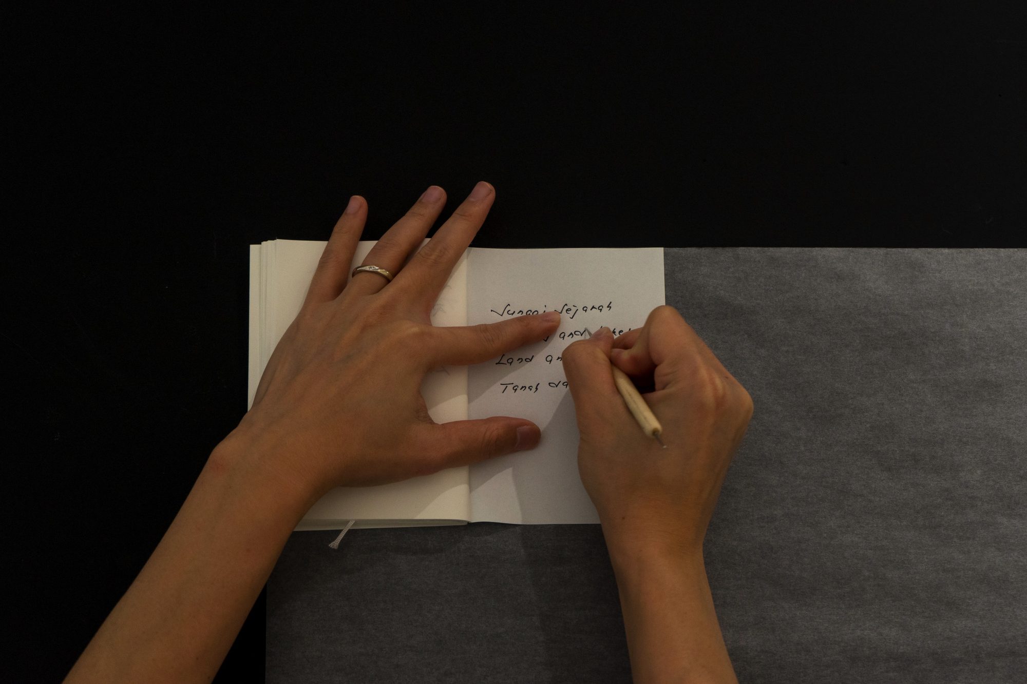 Hands tracing handwritten lines on paper