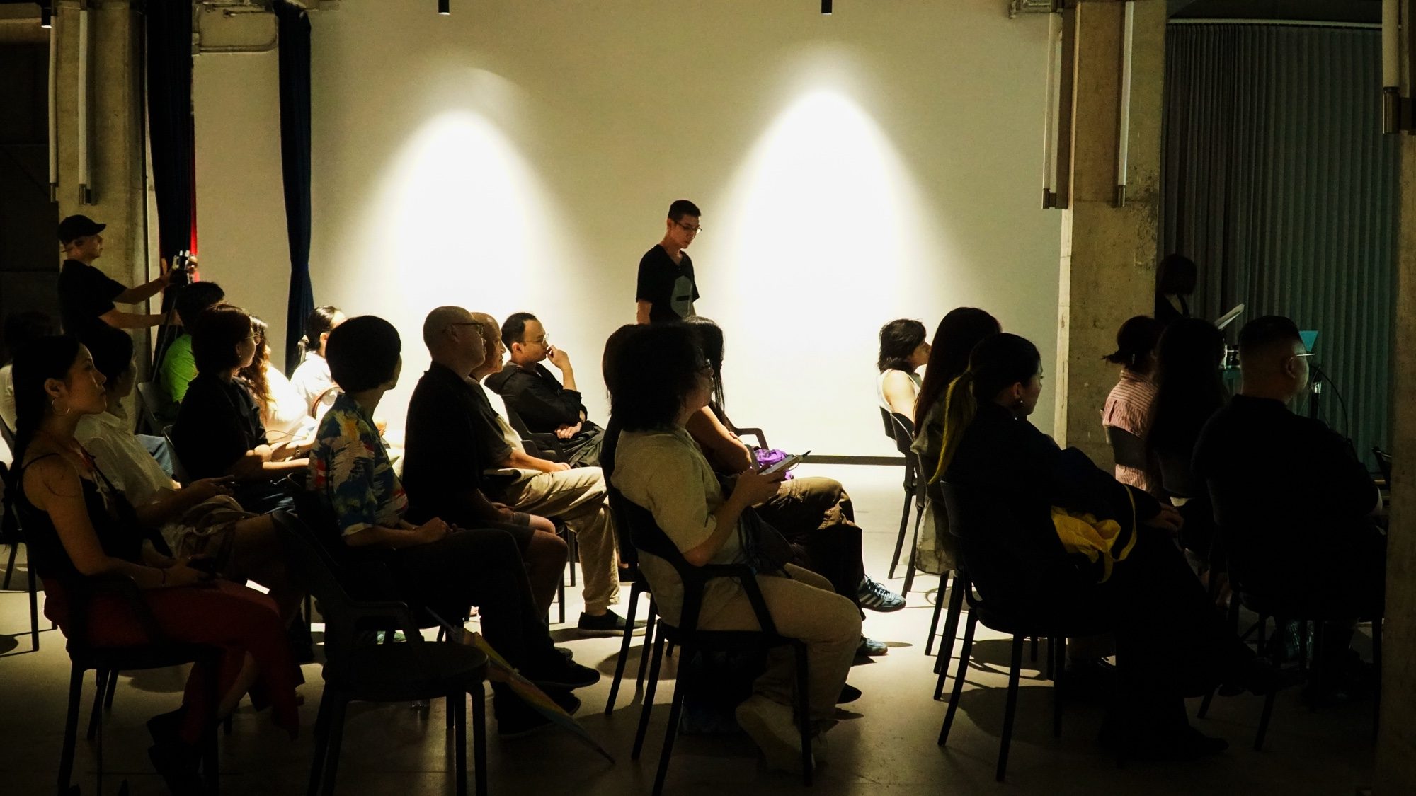 Audience seated in a softly lit room