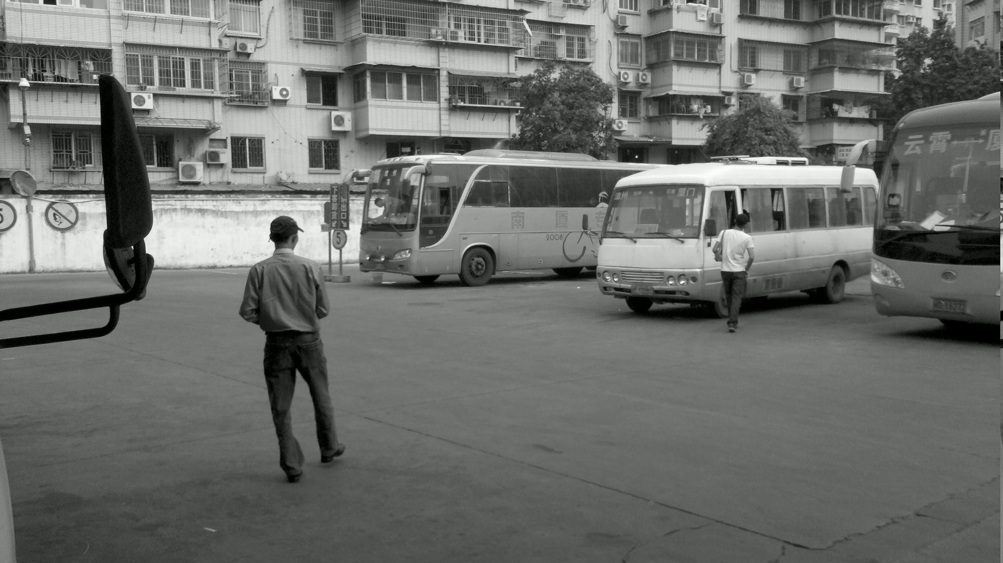 A man walking across a bus station