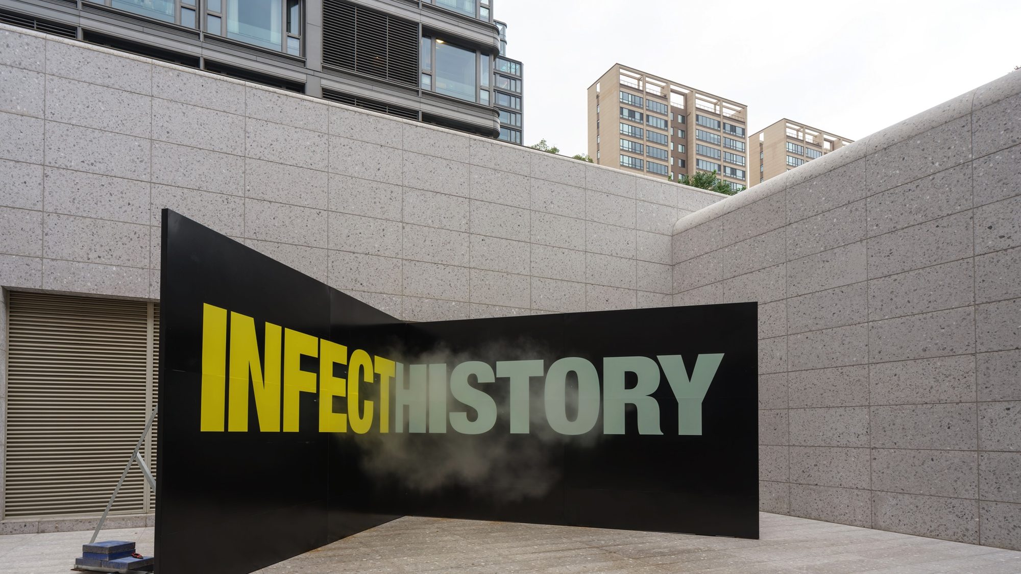 The INFECT HISTORY wall seen from the other side, mist rising over the word HISTORY