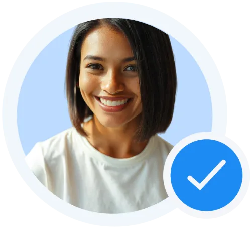 Smiling woman with shoulder-length dark hair wearing a white shirt, with a blue verification checkmark icon overlay.