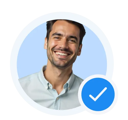 Smiling young man with short dark hair wearing a light blue collared shirt, framed by a circular blue background with a blue verification checkmark overlay.