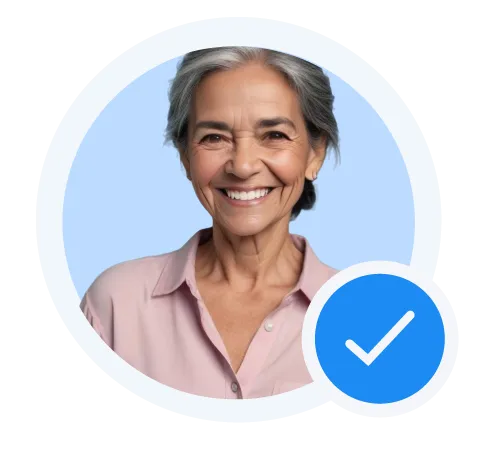 Smiling older woman with gray hair wearing a light pink blouse and a blue verified checkmark badge.