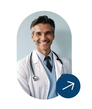 Smiling male doctor wearing white coat and stethoscope against a light background.