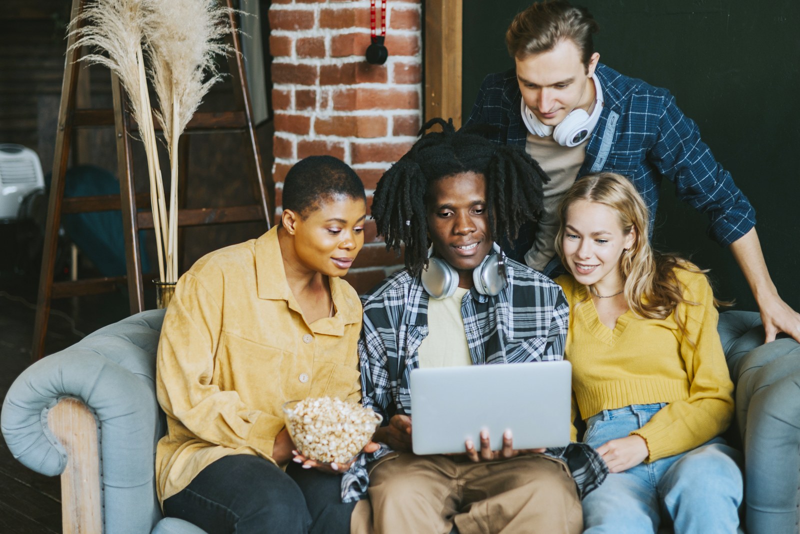 A group of people reading a story on a laptop.