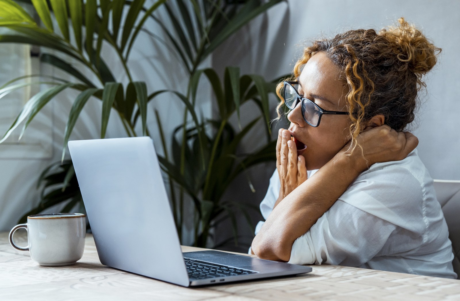 A bored reader on a laptop.