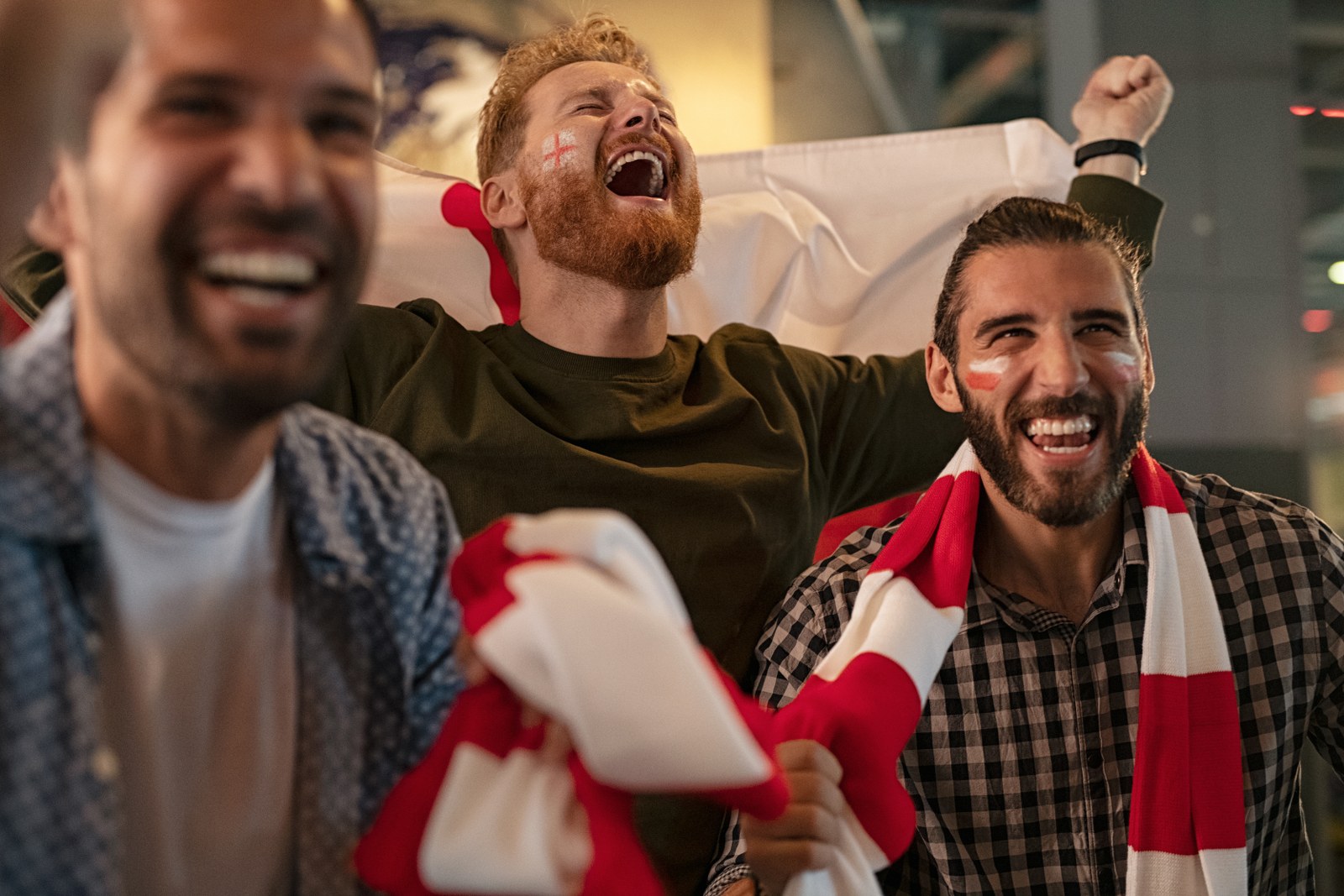 A group of fans celebrating a football victory.