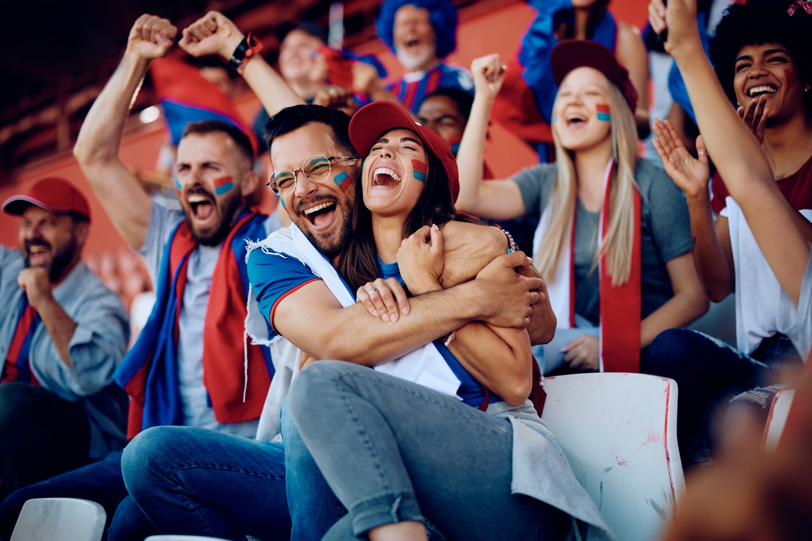 A group of fans having an emotional reaction to a goal.