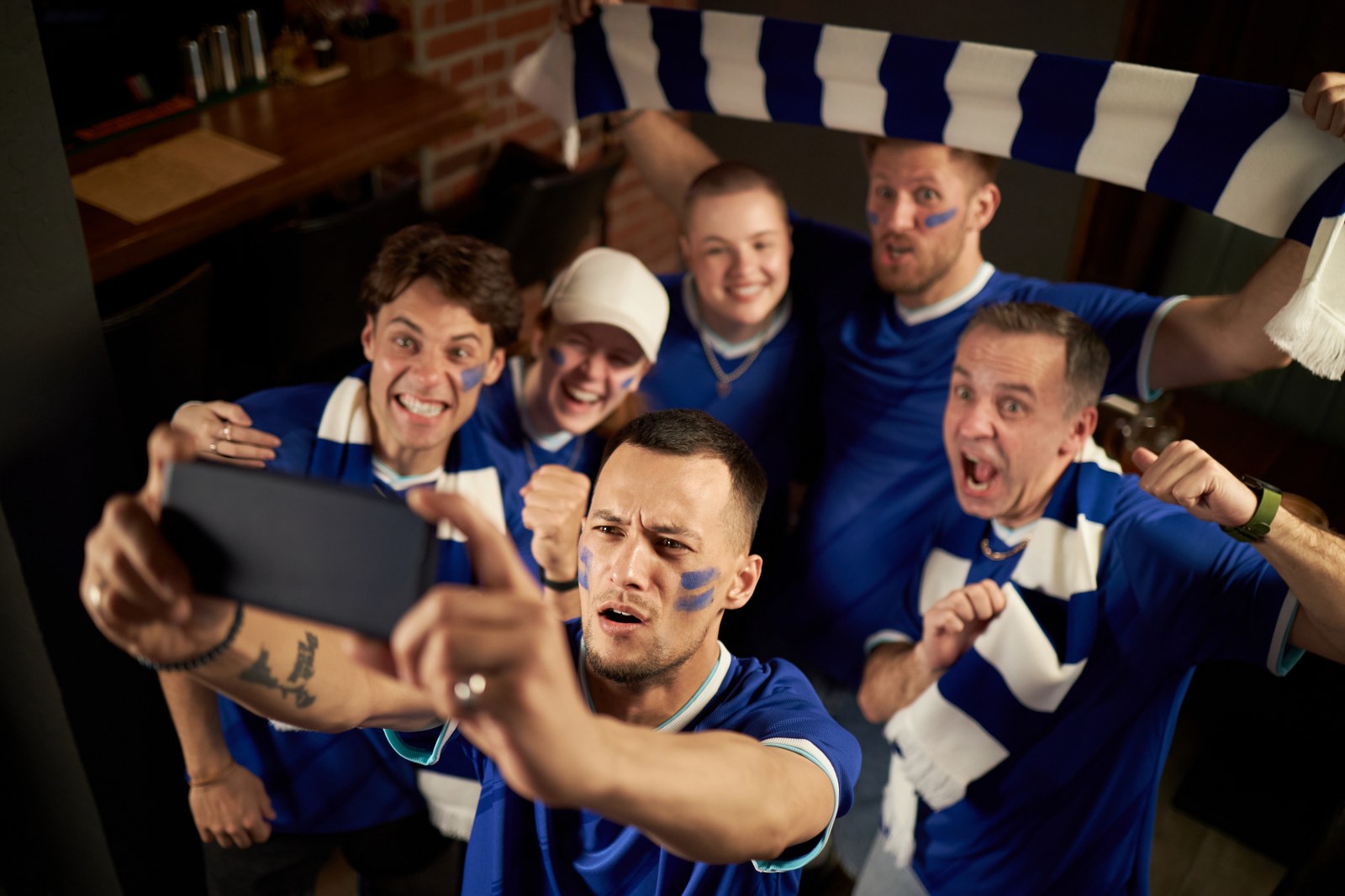 A group of fans making a video.
