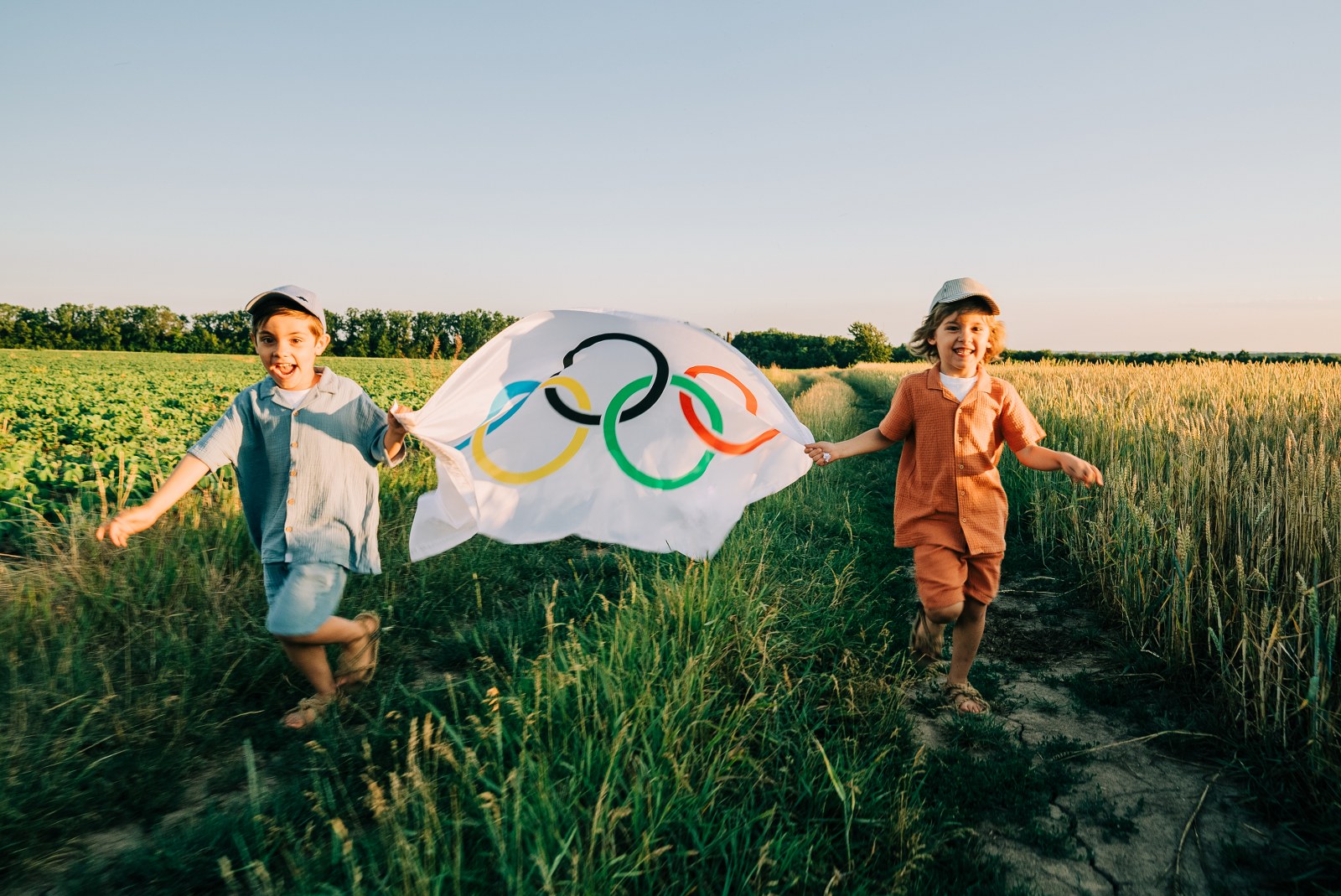 Kid running with an Olympic Games flag.
