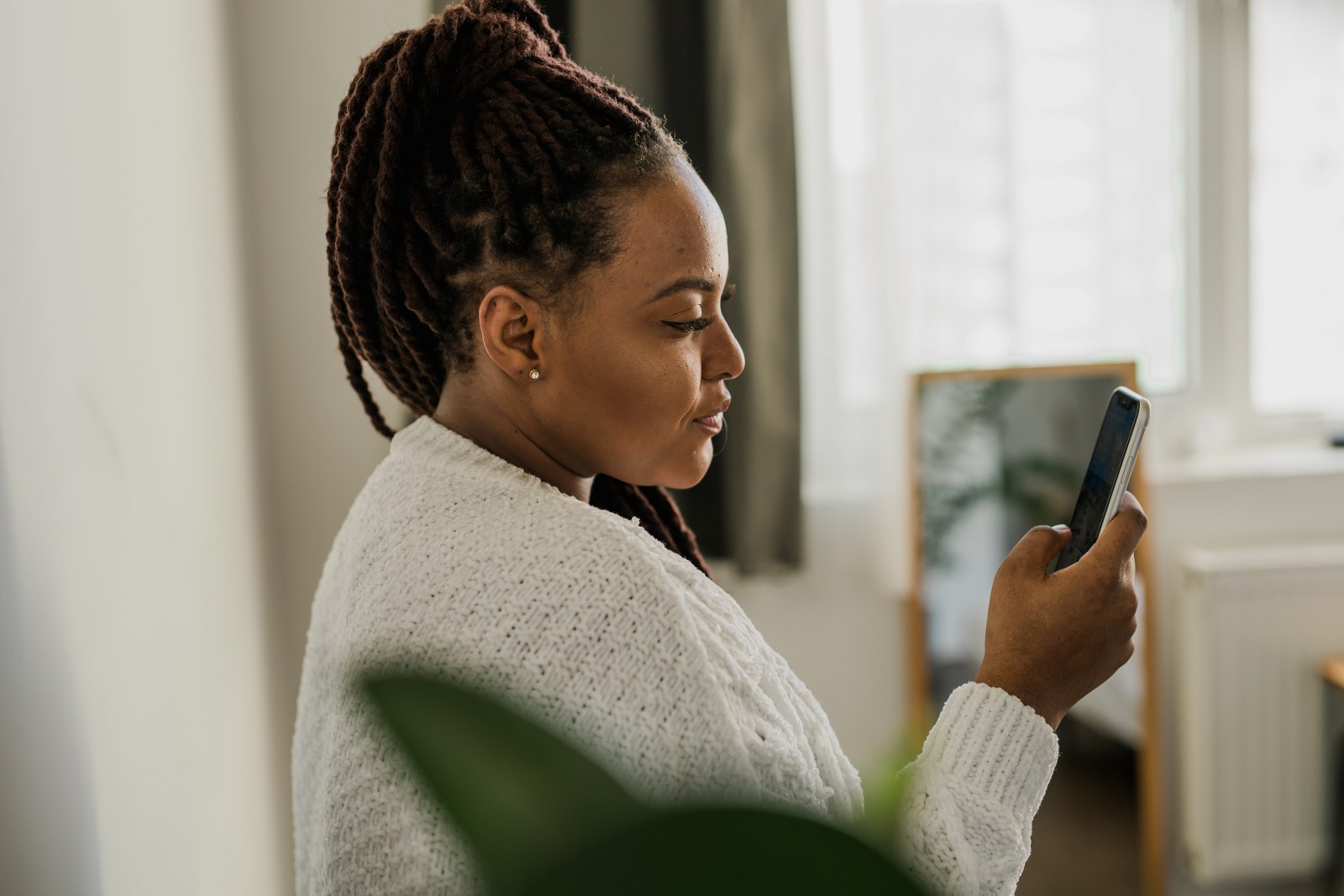 A woman using her phone enjoys interactive mobile content.